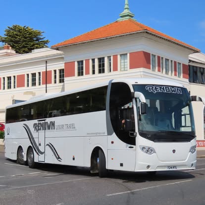 A white Renown luxury coach parked in East Sussex